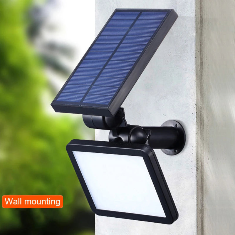 Solar-powered outdoor light fixture mounted on a wall with a blurred green background