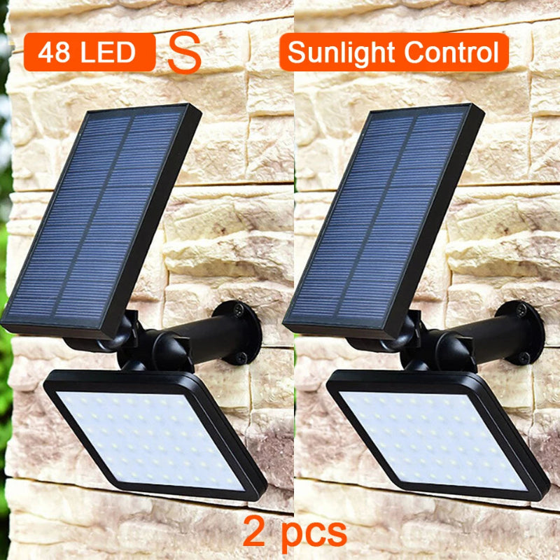 Two solar-powered outdoor lights with 48 LEDs and sunlight control feature on a stone wall background.
