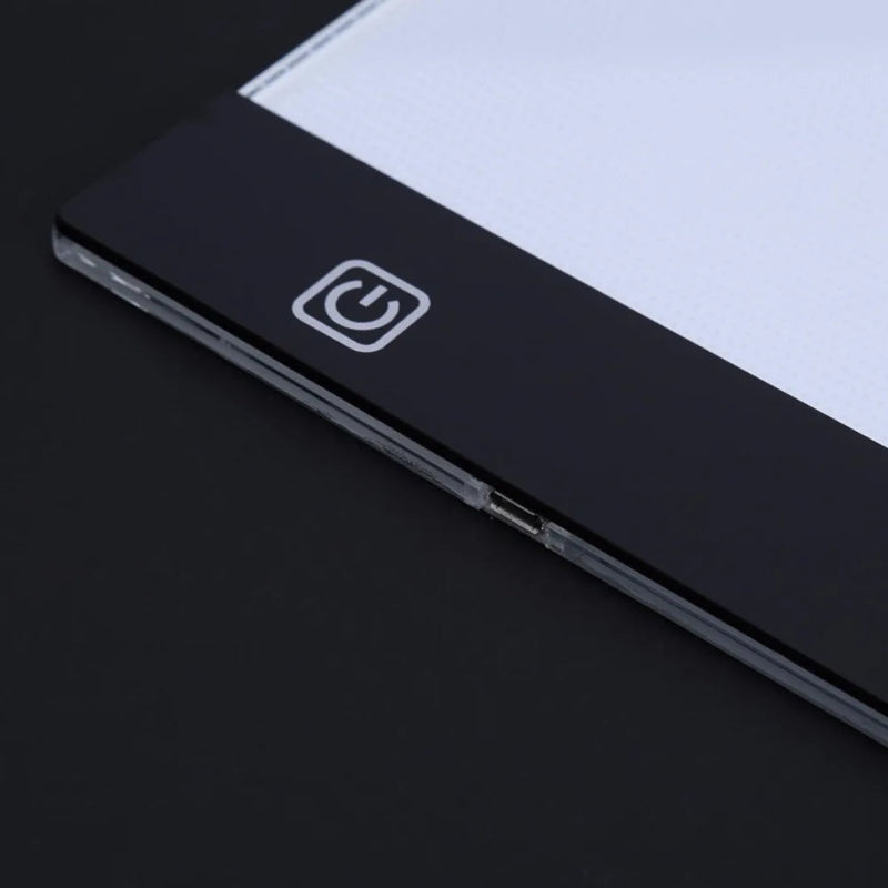 Close-up of a black electronic device with a power symbol on a dark background