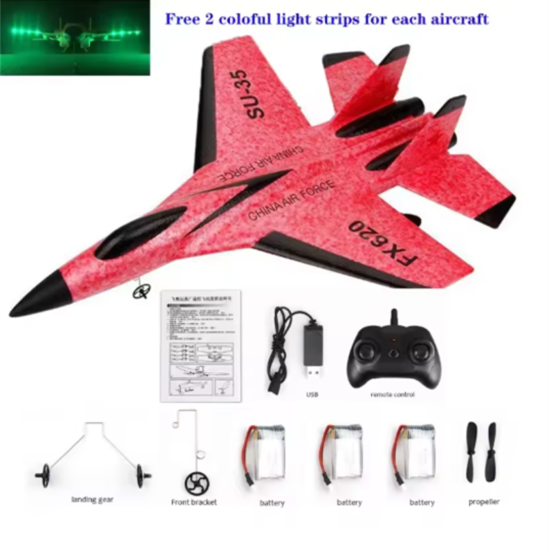 Red toy airplane with remote control and accessories on a white background