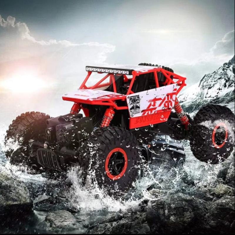 Red monster truck crossing a river with mountains in the background