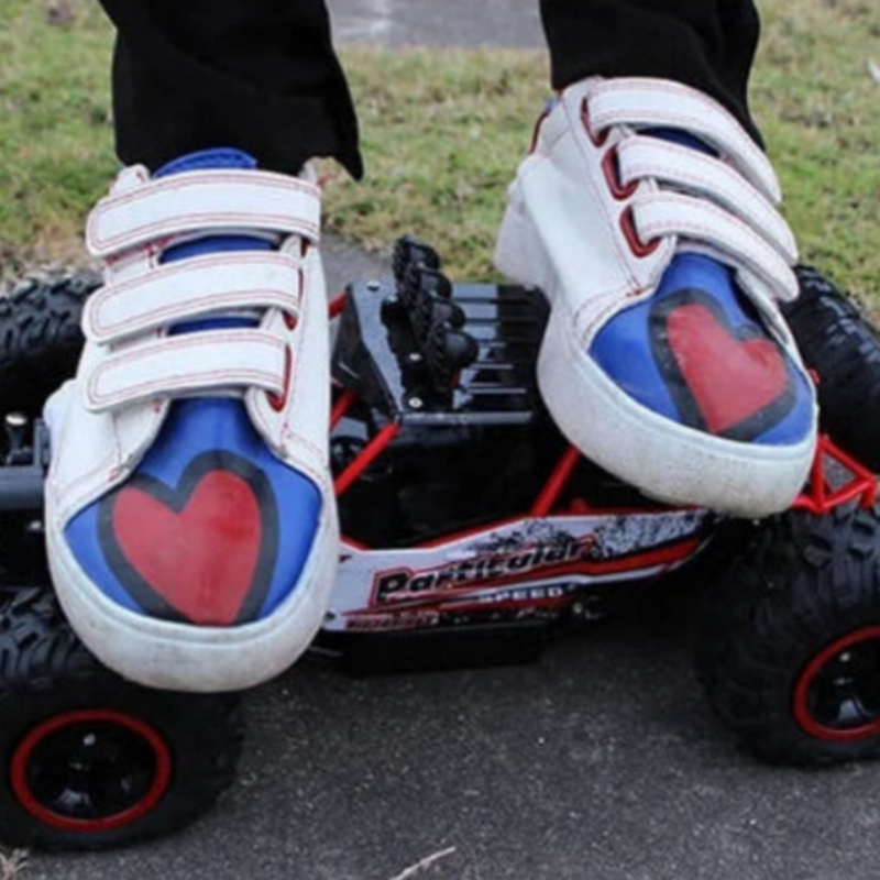 White sneakers with red and blue hearts on a remote-controlled car