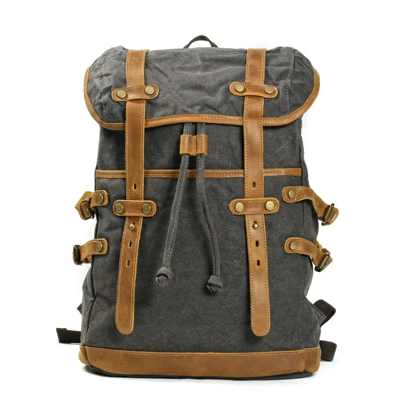 Gray backpack with brown leather straps on a white background
