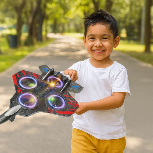 Child holding a toy drone in a park