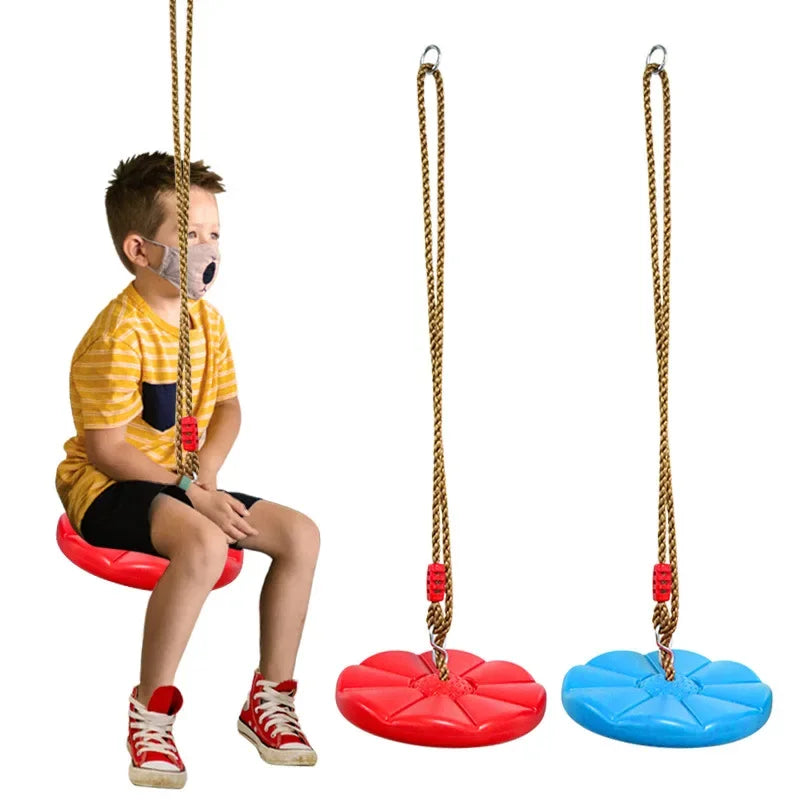 Child sitting on a red swing with two additional swings, one red and one blue, on a white background.