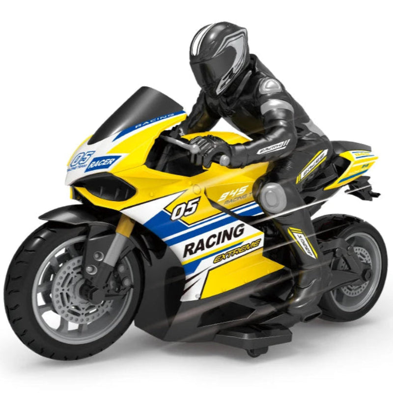 A person holding a blue remote-controlled motorcycle toy with a figurine rider wearing a black and white suit.