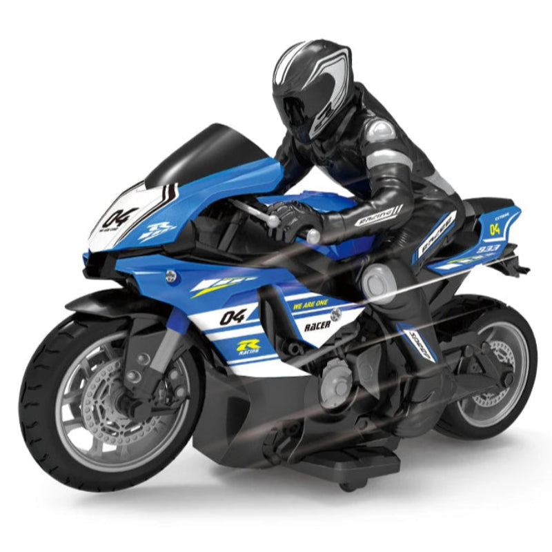 A person holding a blue remote-controlled motorcycle toy with a figurine rider wearing a black and white suit.