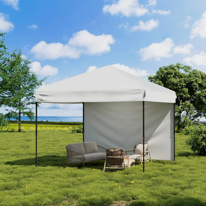 Outdoor gazebo with furniture on a grassy area under a blue sky.