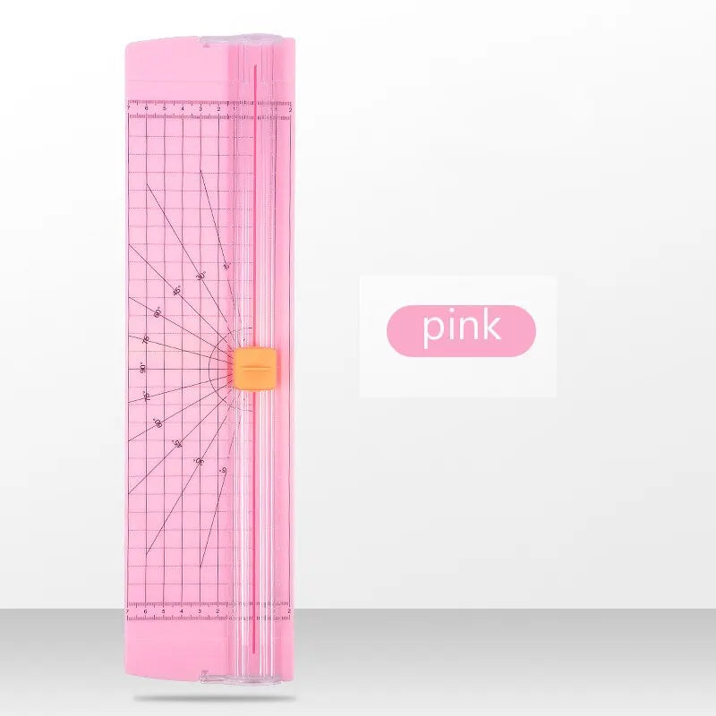 Pink paper cutter with grid on a white background