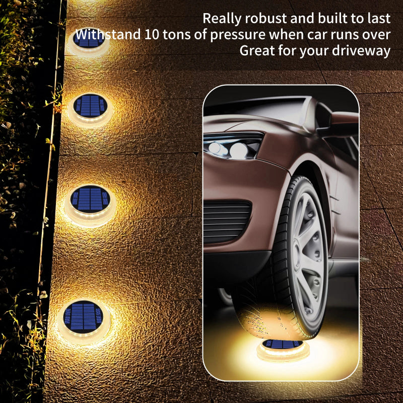 Solar-powered driveway lights with a car wheel test graphic on a driveway.