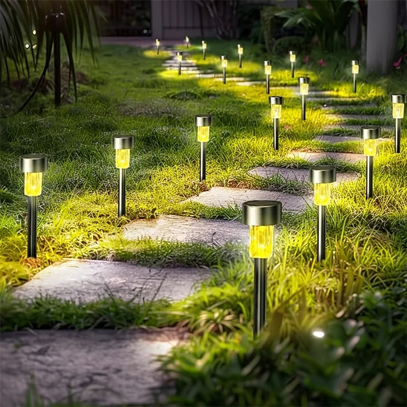 Solar garden lights illuminating a pathway in a garden