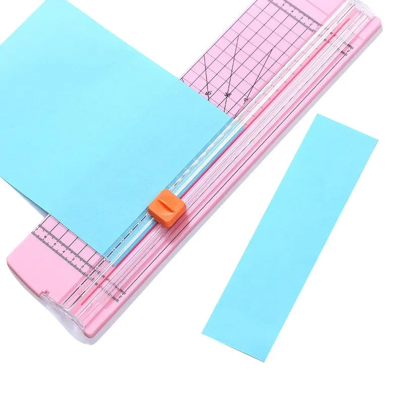 Paper cutter with pink and blue components on a white background