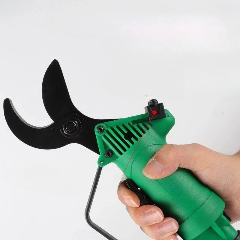 Hand holding a green and black pruning shear against a white background