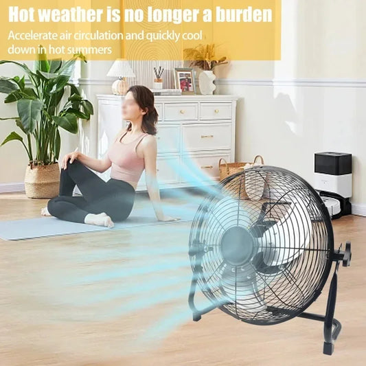Woman sitting on a yoga mat with a standing fan in a room, promoting air circulation.