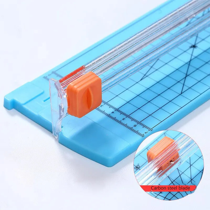 Blue paper cutter with carbon steel blade on a white background