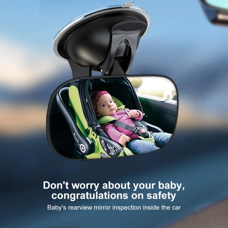 Baby in a car seat reflected in a rearview mirror with text about safety.