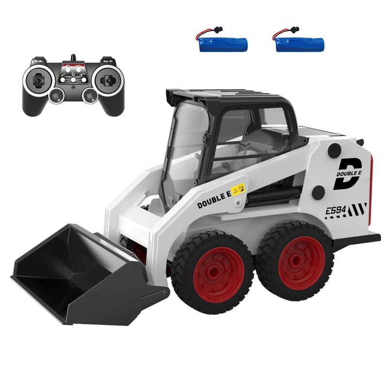 A white and black remote-controlled toy skid steer loader with red wheels and a black bucket, shown with a black remote controller and two blue batteries on a white background.