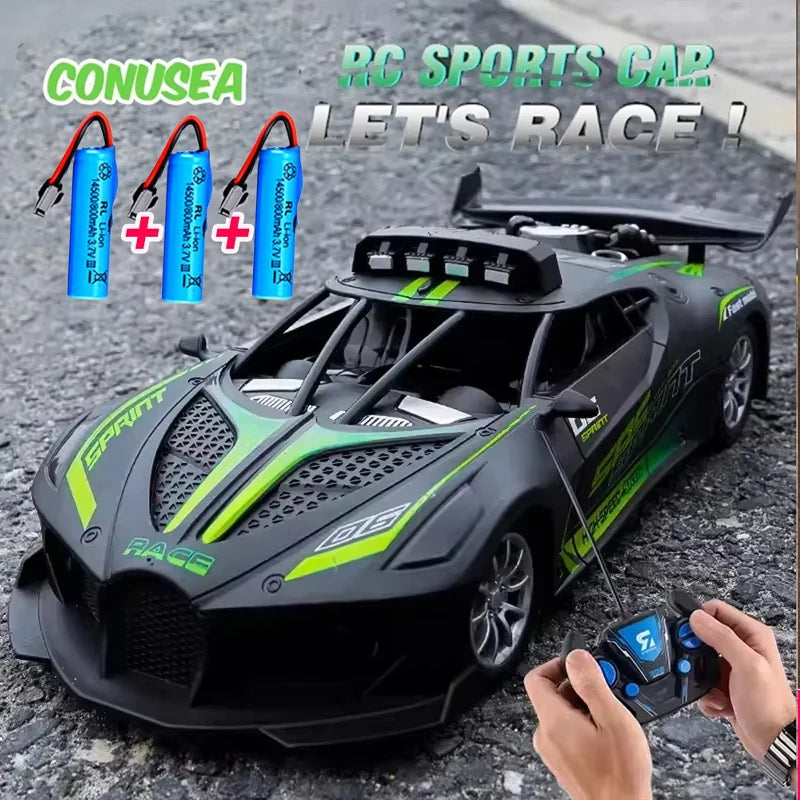 Toy RC sports car with remote control and batteries on a textured surface