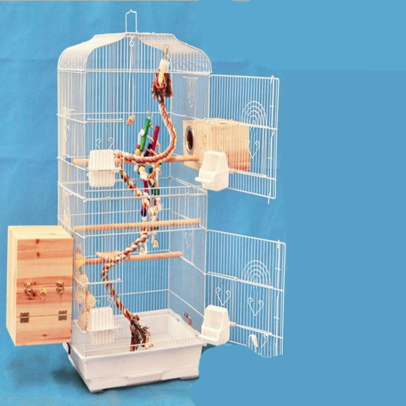 Bird cage with wooden and plastic accessories on a blue background