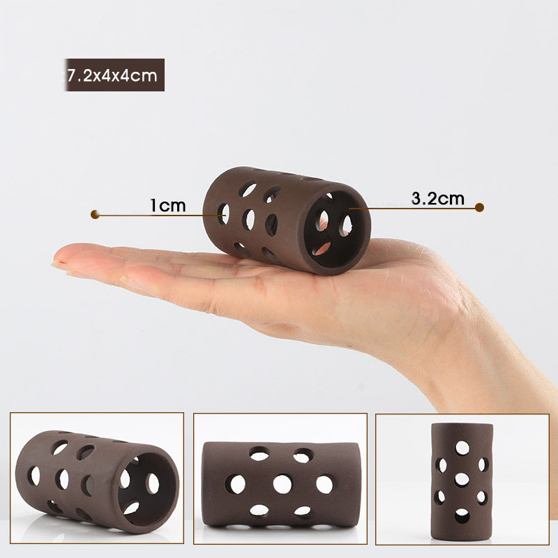 Brown cylindrical object with holes held in a hand for scale, showing dimensions.