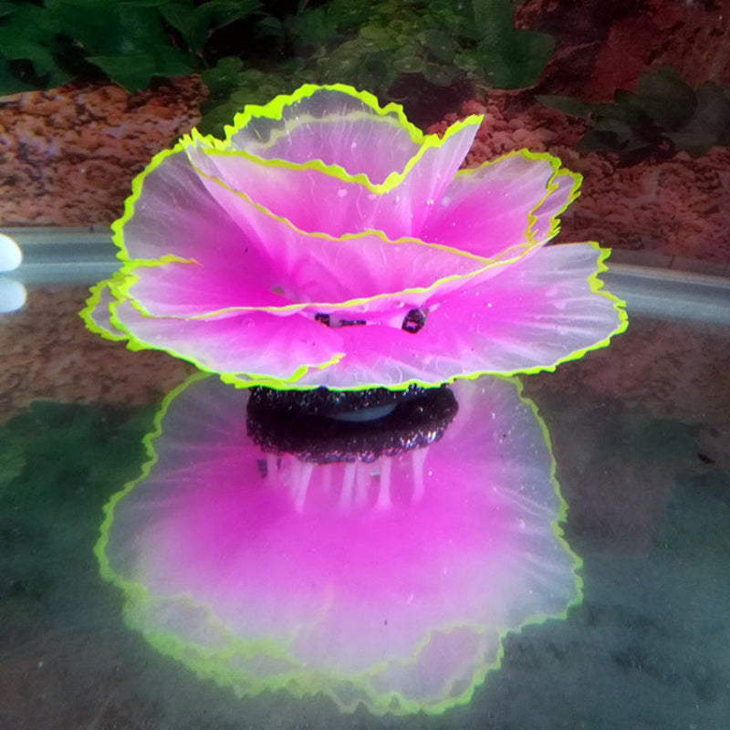 Pink and green decorative item on a reflective surface with blurred background