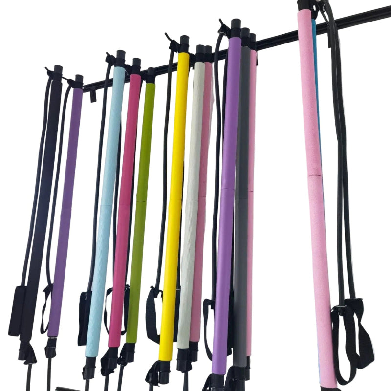 Set of colorful resistance bands hanging on a rack against a white background