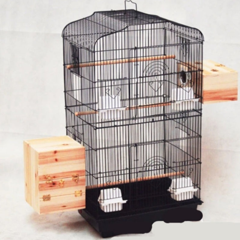 Black bird cage with wooden perches on a white background