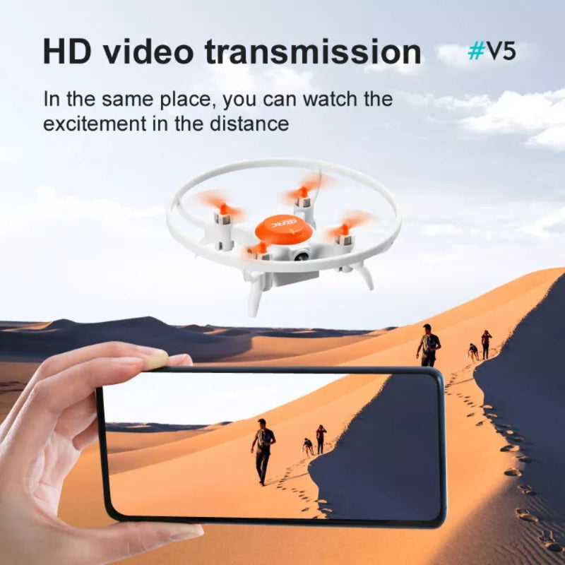 Drone hovering above a desert with a person holding a phone watching a video of people walking in the distance.