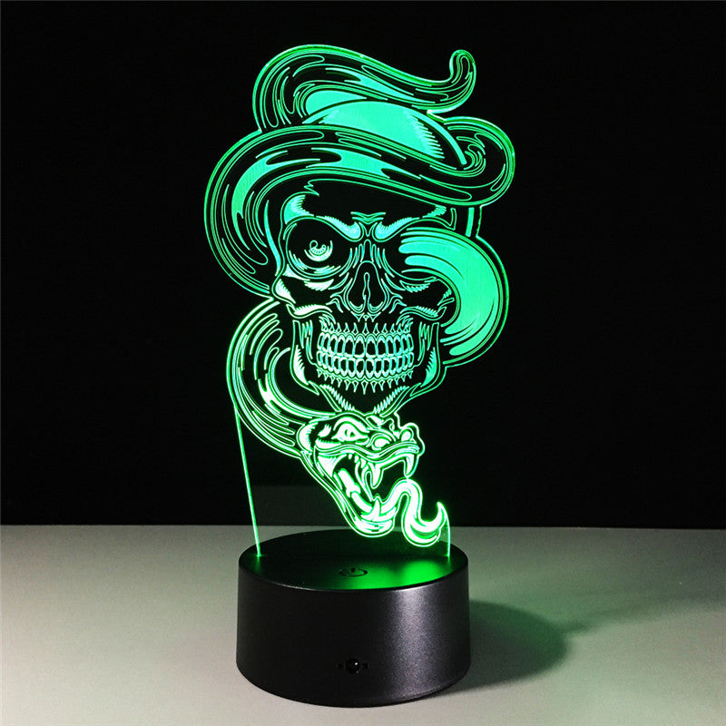 A 3D optical illusion LED night light featuring a glowing green skull wearing a hat and smoking a cigar, mounted on a black cylindrical base against a dark background.