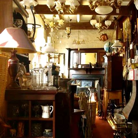 Shows a store with all kinds of antiques and collectibles.